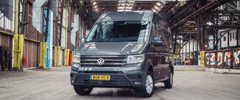 Grijze Volkswagen bestelbus geparkeerd in een grote industriële hal